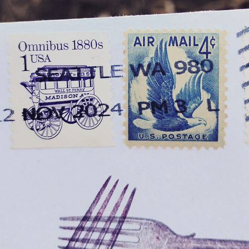 Envelope with postage stamps. A one cent stamp with a line drawing of a stagecoach and a 4 cent air mail stamp with a flying eagle. 